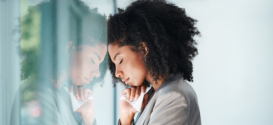 Shot of a young businesswoman looking stressed out in an office
